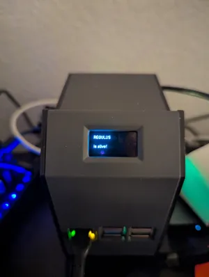 OLED showing REGULUS is alive! boot message
